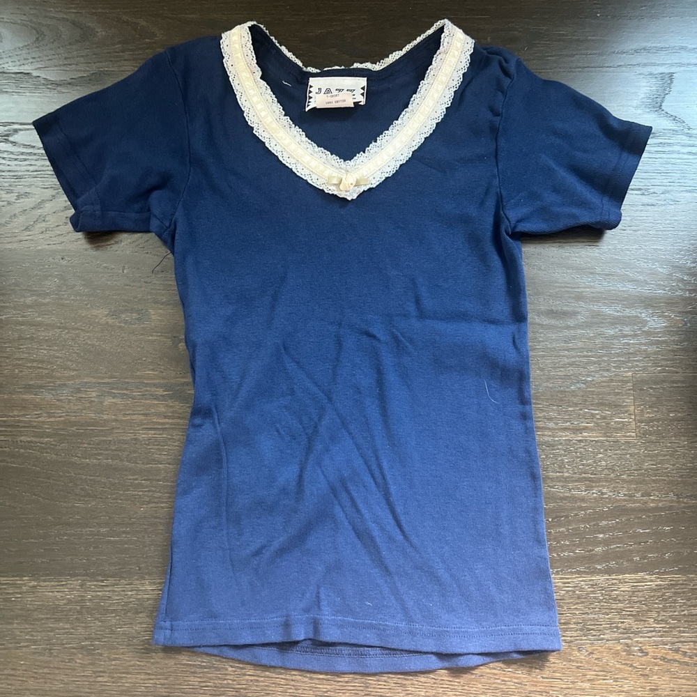 Adorable, vintage, navy tee. It says size medium but looks more like XS.